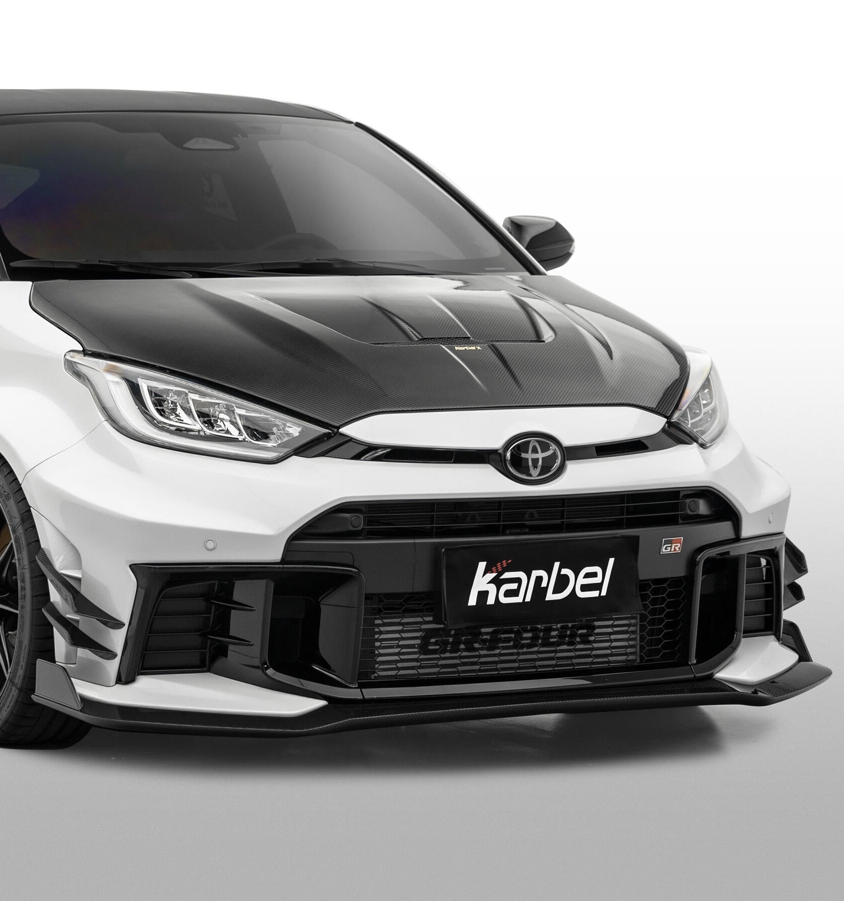 Toyota GR Yaris GXPA16 Facelift 2024-ON with Aftermarket Parts - X Front Lip Dry Pre-preg Carbon Fiber from Karbel Carbon