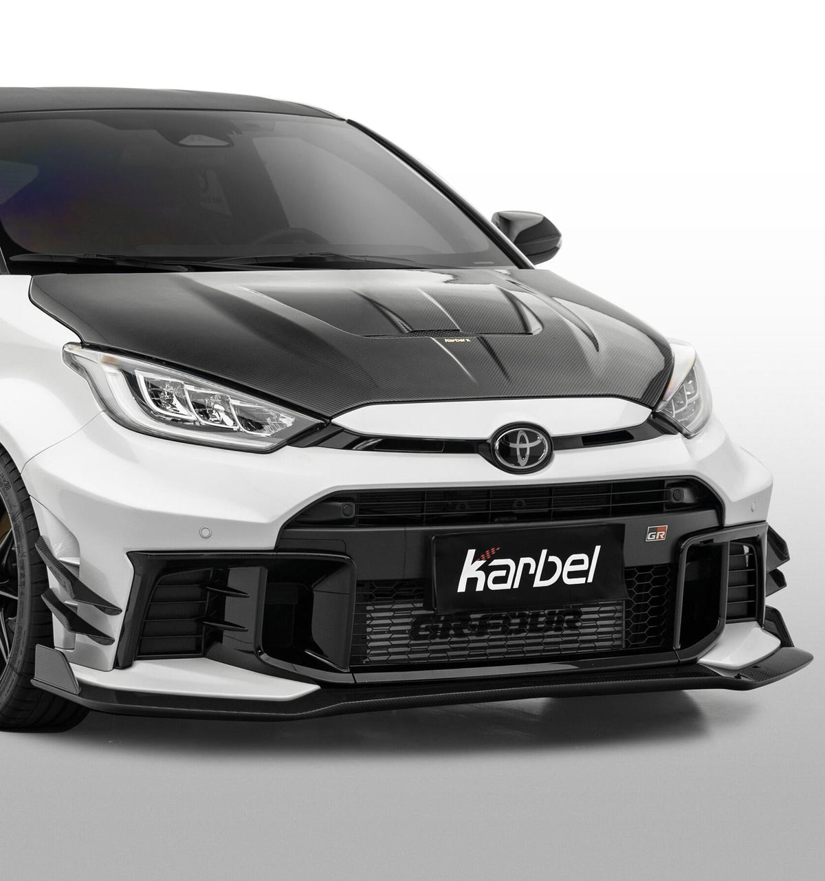 Toyota GR Yaris GXPA16 Facelift 2024-ON with Aftermarket Parts - X Front Lip Dry Pre-preg Carbon Fiber from Karbel Carbon